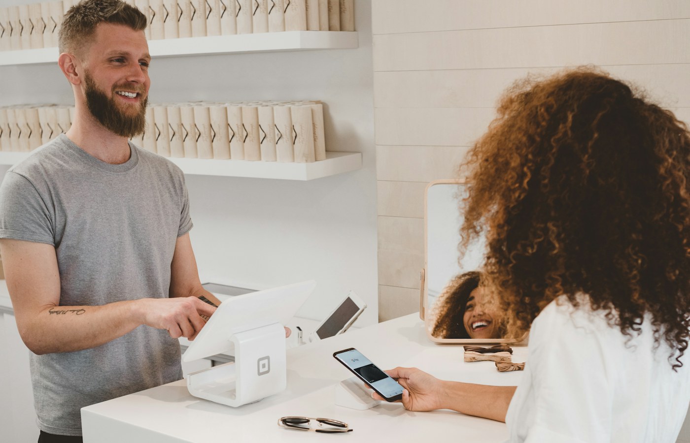 A business owner helping a customer at a counter